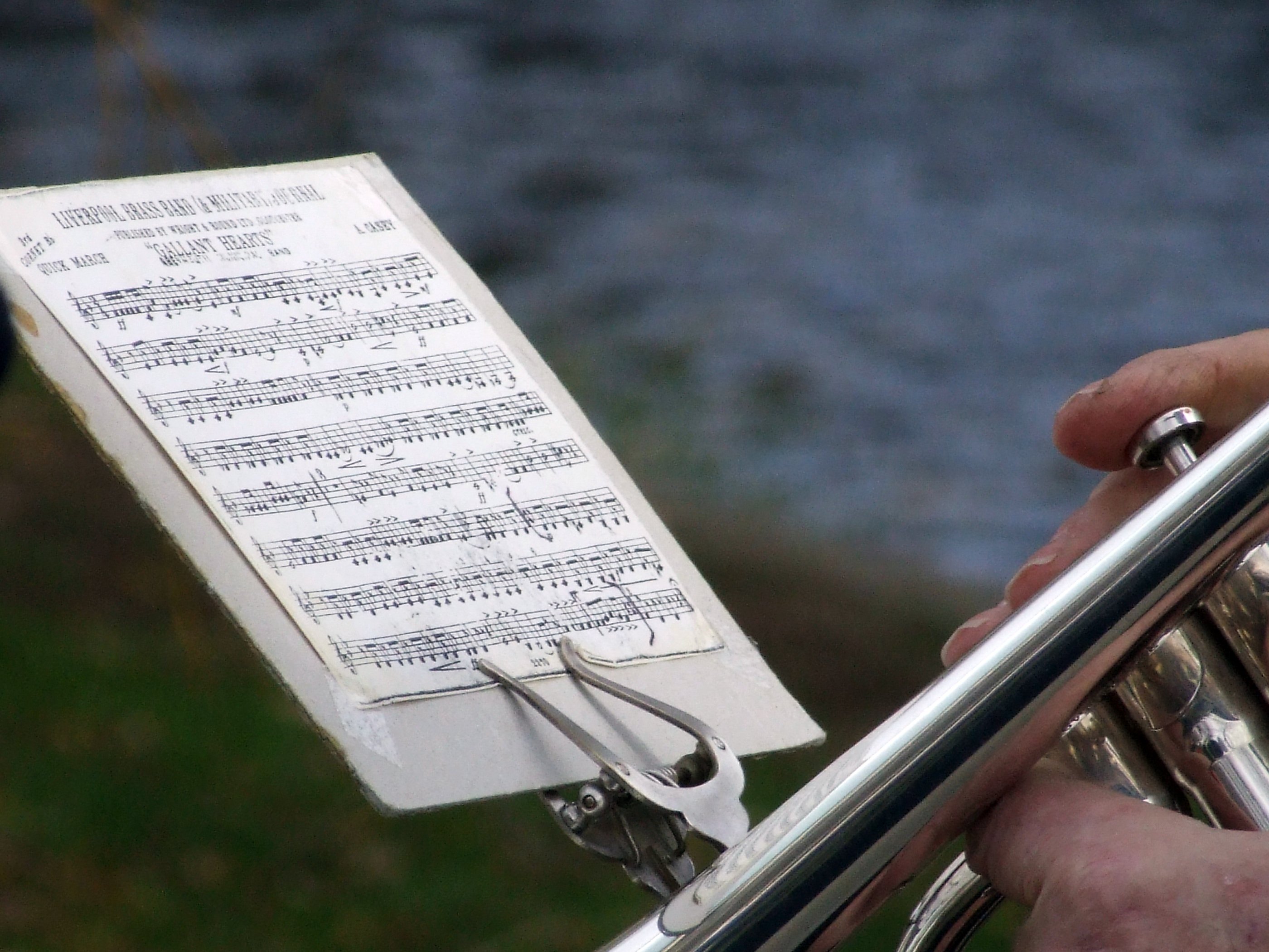 Trumpet resting beside sheet music